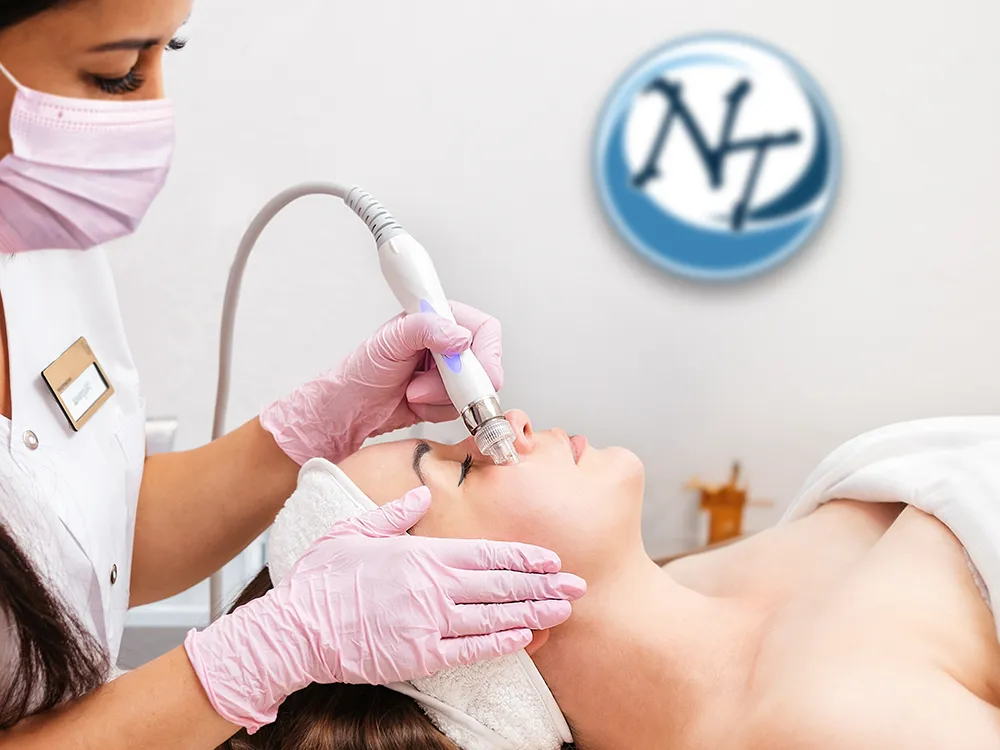 Esthetician performing a Hydro Aqua Facial with a handheld wand